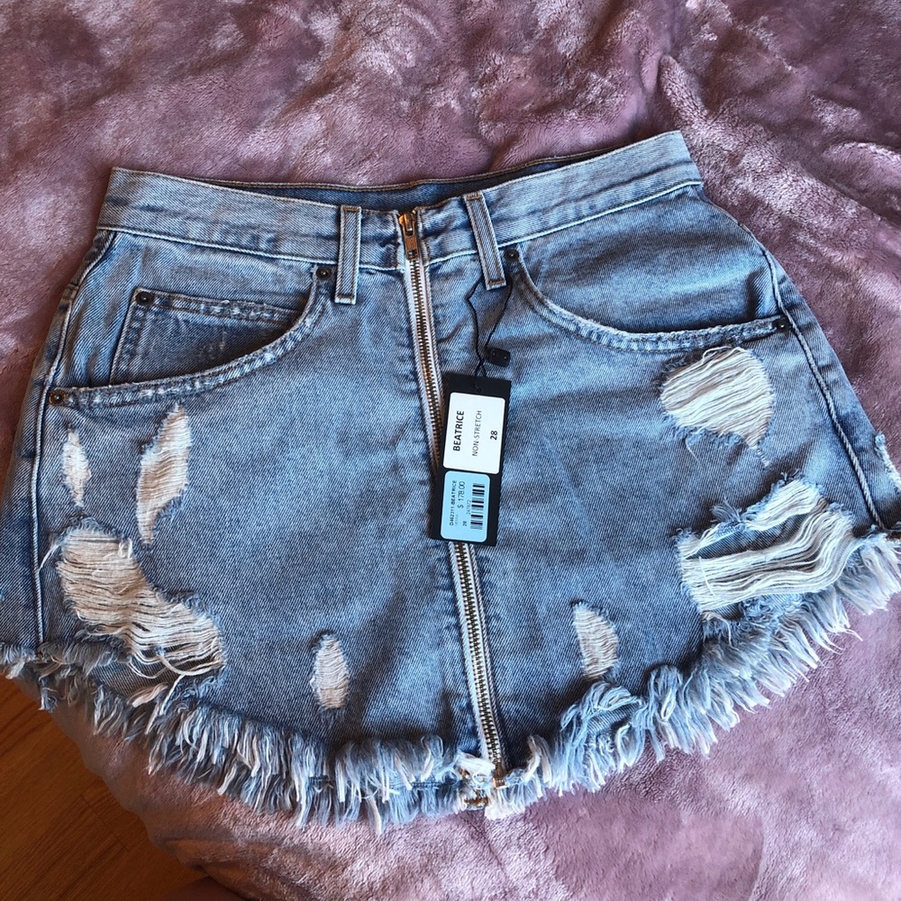 Carmar denim skirt. Distressed look light wash